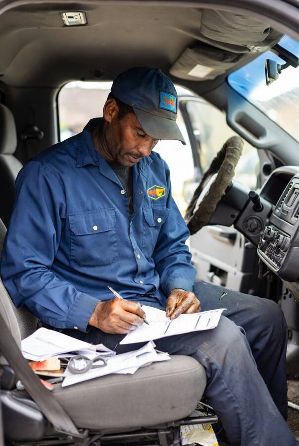 Technician filling out paperwork in truck